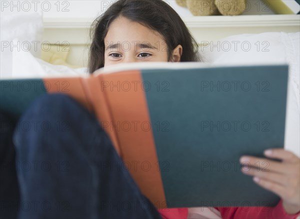 Mixed race girl reading a book