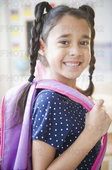 Mixed race girl in backpack