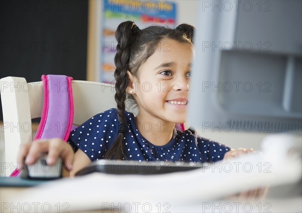 Mixed race girl using computer