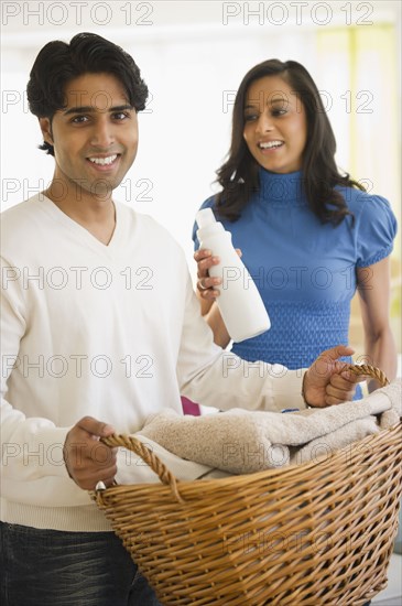 Mixed race couple doing laundry