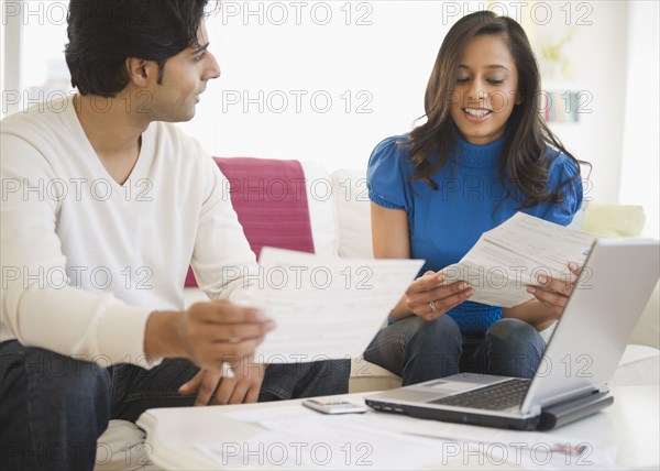 Mixed race couple paying bills online