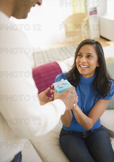 Mixed race man giving girlfriend a gift