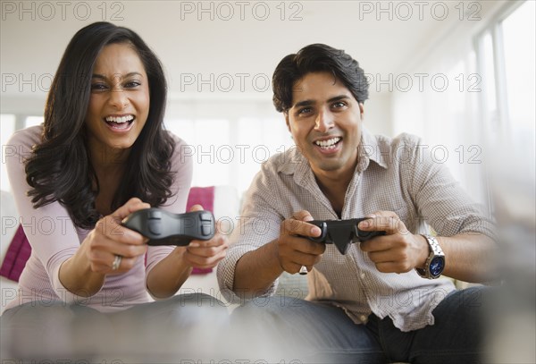 Mixed race couple playing video game