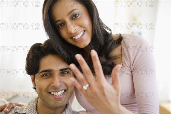Mixed race woman showing off engagement ring