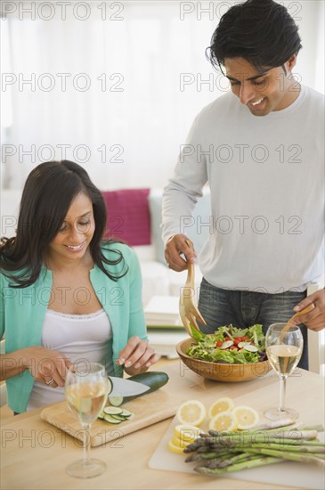 Mixed race couple preparing salad