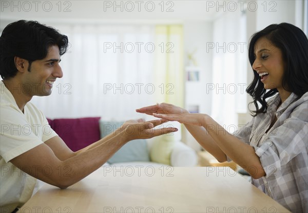 Mixed race couple playing slapping game