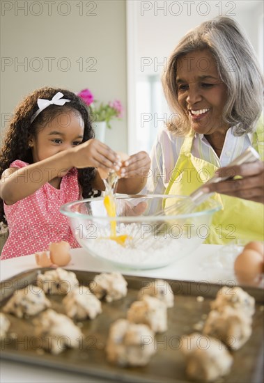 African American grandmother and granddaughter baking cookies