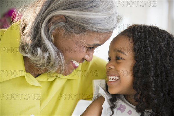 Smiling African American grandmother and granddaughter