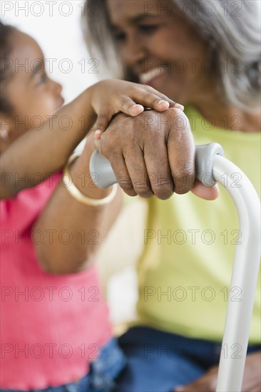 African American girl holding hands with grandmother