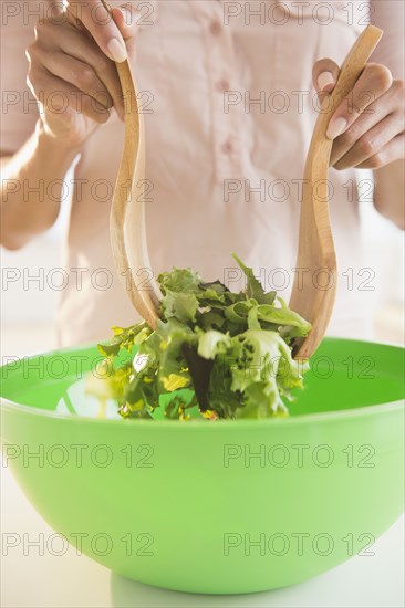 Cape Verdean woman tossing a salad