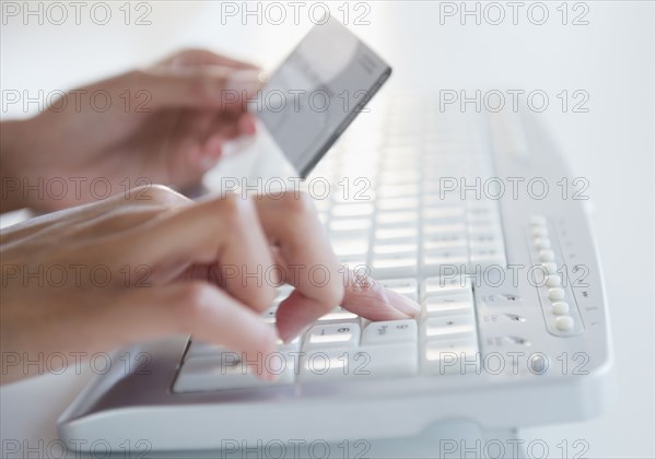 Cape Verdean woman shopping online with credit card