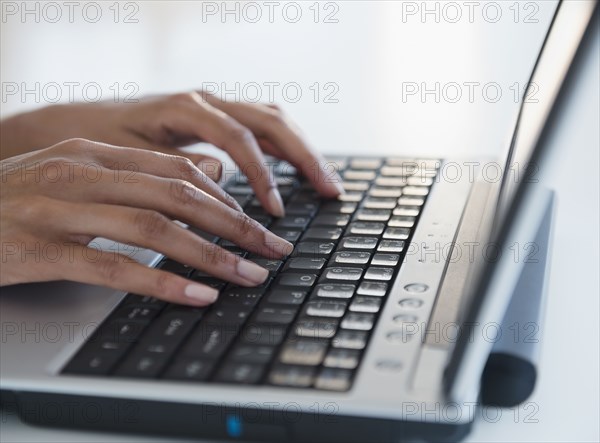 Cape Verdean woman typing on laptop