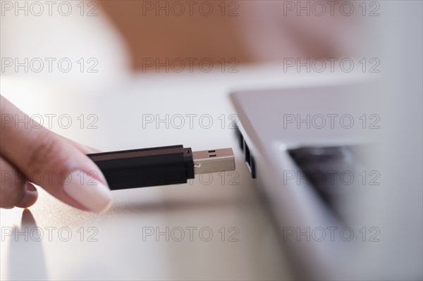 Cape Verdean woman using USB device