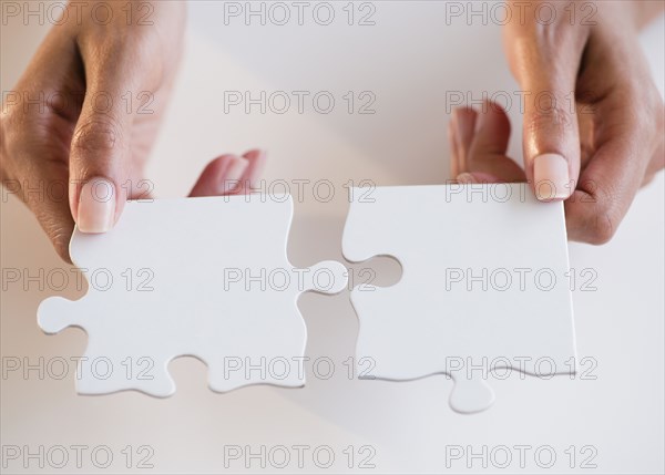 Cape Verdean woman holding puzzle pieces