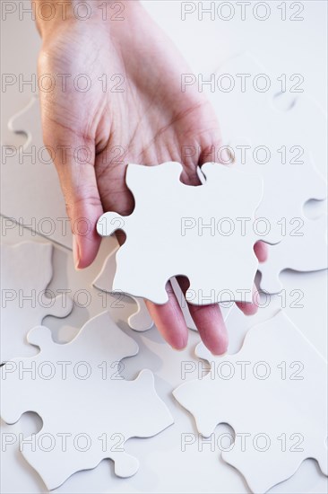 Cape Verdean woman holding puzzle piece