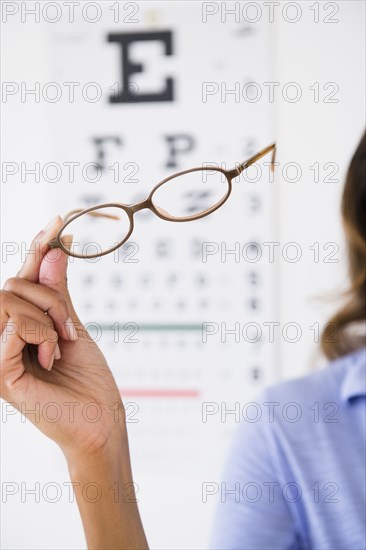 Cape Verdean woman holding eyeglasses