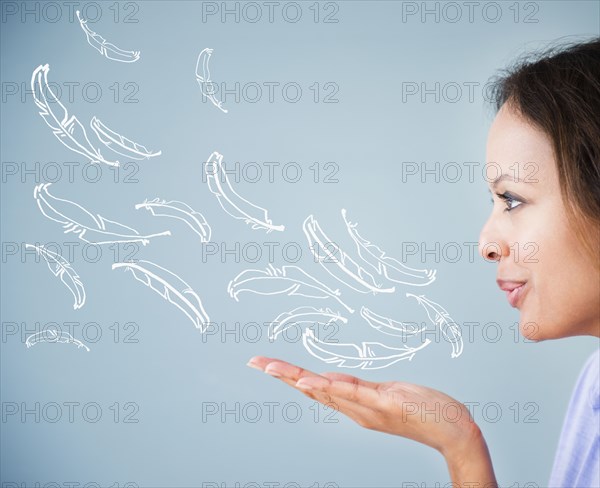 Cape Verdean woman blowing illustrations of feathers