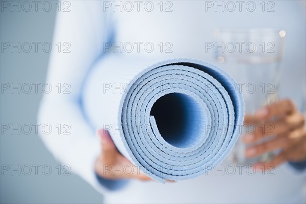 Cape Verdean woman holding yoga mat