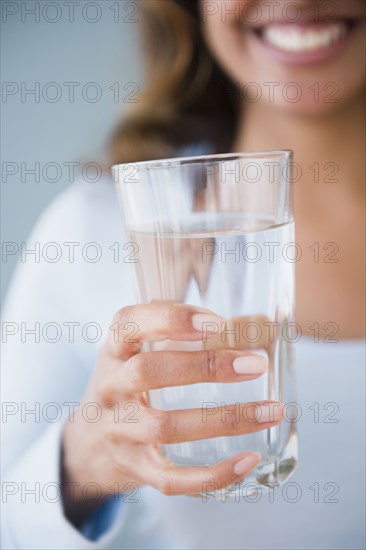 Cape Verdean woman holding glass of water