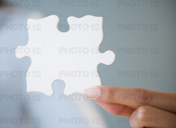 Cape Verdean woman holding puzzle piece