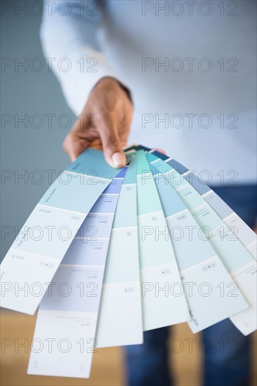 Cape Verdean woman holding color swatches