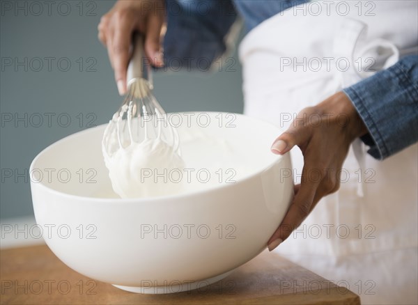 Cape Verdean woman whisking cream