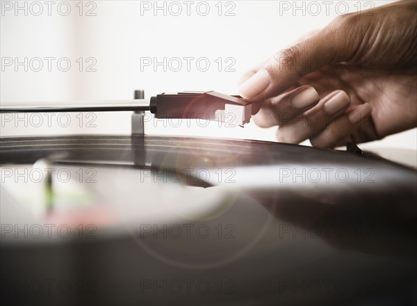 Cape Verdean woman listening to vinyl record