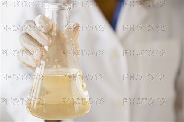 Cape Verdean scientist holding chemical in beaker