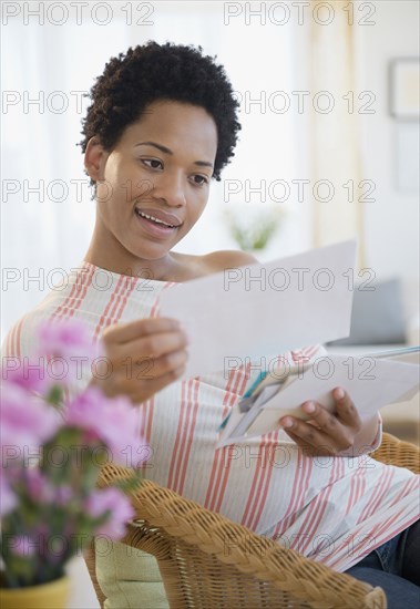 African American woman looking at mail