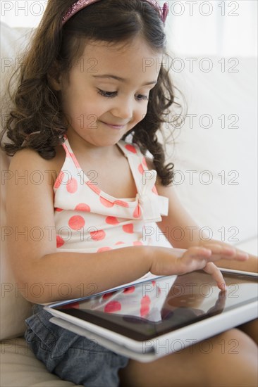 Mixed race girl using digital tablet