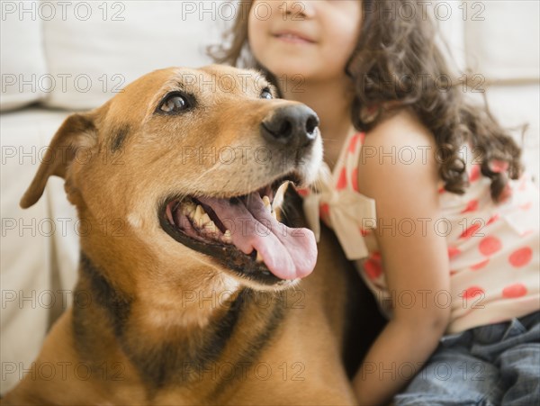 Mixed race girl sitting with dog