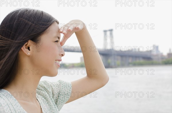 Asian woman looking at urban cityscape