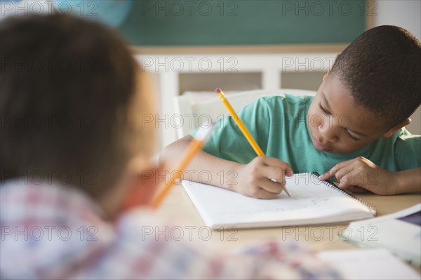 Children writing in classroom