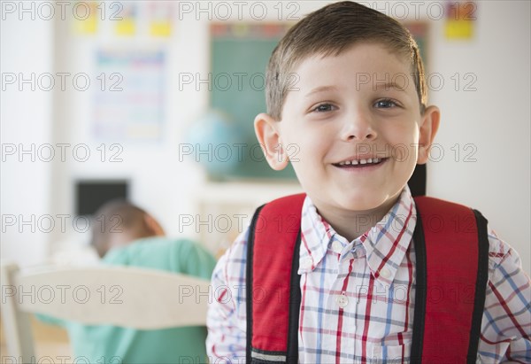 Smiling Caucasian boy in classroom