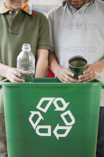 Boys recycling together