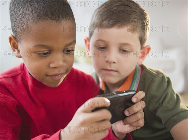 Boys looking at cell phone together