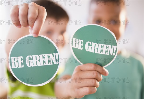 Boys holding Be Green signs