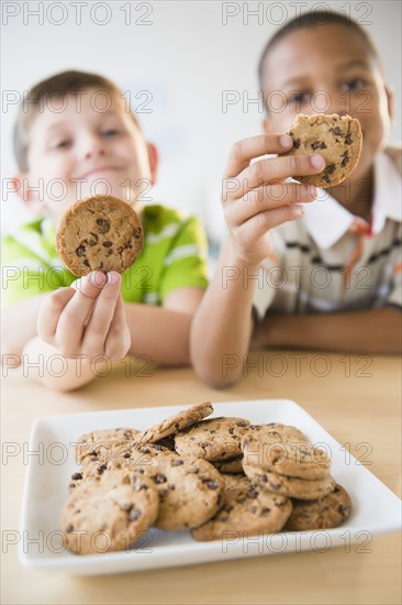 Boys eating chocolate chip cookies