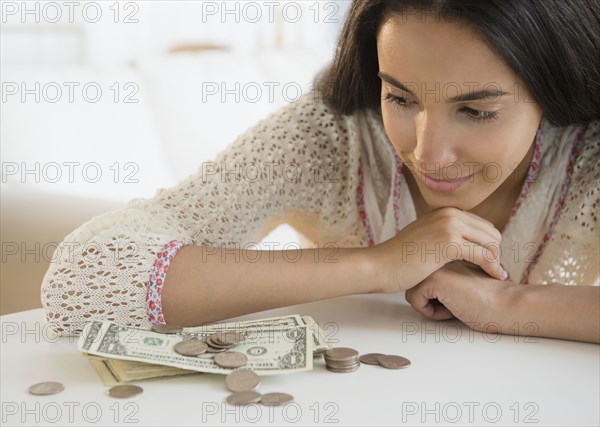 Hispanic teenager looking at money