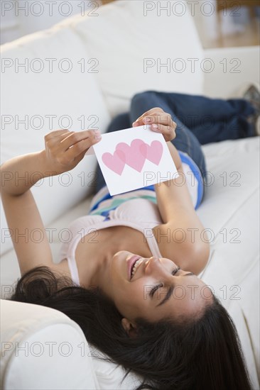 Hispanic teenager reading Valentine's Day card