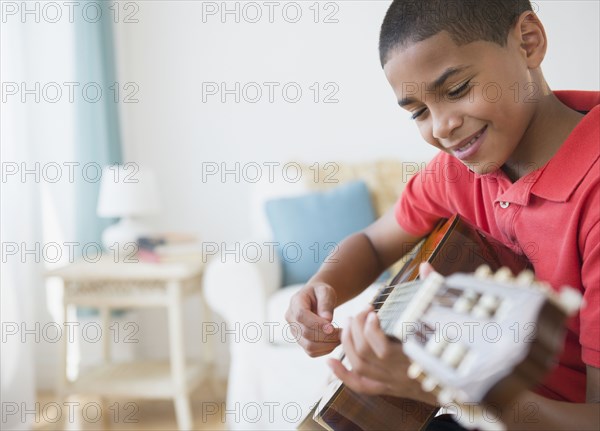 Hispanic boy playing guitar