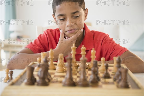 Hispanic boy playing chess