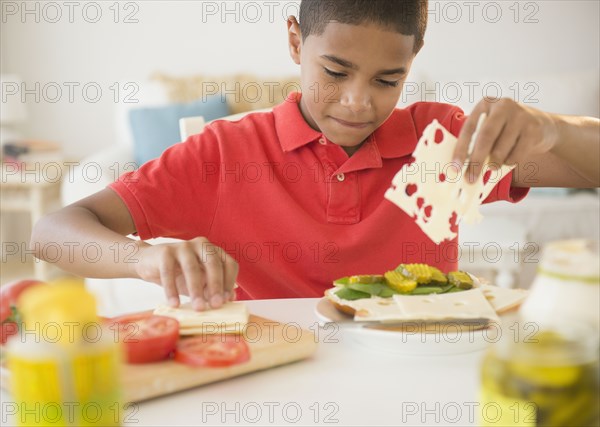 Hispanic boy making sandwich