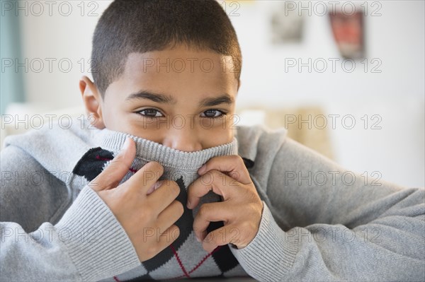 Hispanic boy hiding his face