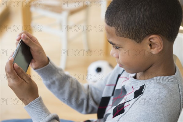 Hispanic boy using cell phone