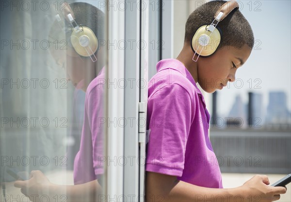 Hispanic boy listening to music on headphones