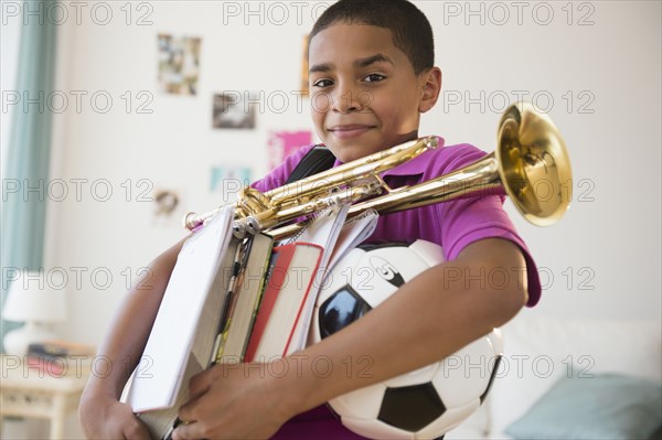 Hispanic boy carrying trumpet