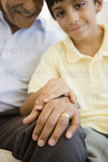 Hispanic grandfather and grandson holding hands