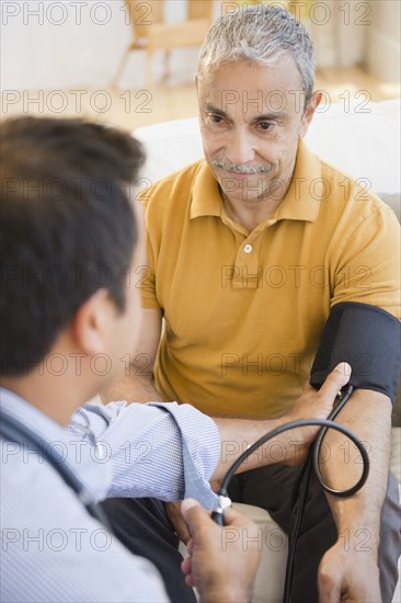 Hispanic man having his blood pressure taken