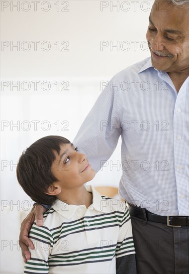 Hispanic grandfather smiling at grandson